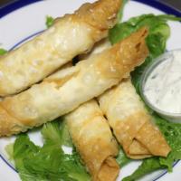 Cigar Rolls (4Pcs) · Cigar shaped crispy pastries stuffed with feta cheese and parsley served with tzatziki sauce.