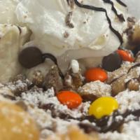 Reese'S Lover  · Vanilla Ice Cream on the side
Reese's Chunks sprinkled on funnel cake 
Whip Cream, Chocolate...