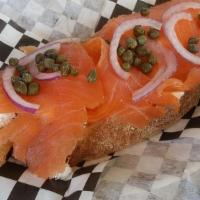 Smoked Salmon Slicer · Sliced wild-caught smoked salmon, goat cheese, red onions, and capers. One of a kind.