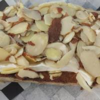 Melted Brie Slicer · Melted French brie cheese, sliced almonds, drizzled with local honey.