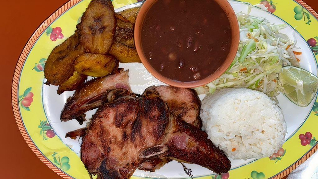 Chuleta Ahumada / Smoked Pork Chop · ARROZ BLANCO, ENSALADA DE REPOLLO, 2 TORTILLAS DE MAIZ Y, FRIJOLES FRITOS.