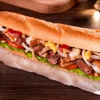 Pepito Mixed Sub · Lettuce, onions, tomatoes, potato sticks, mustard, ketchup, and engy sauce on a baguette bre...