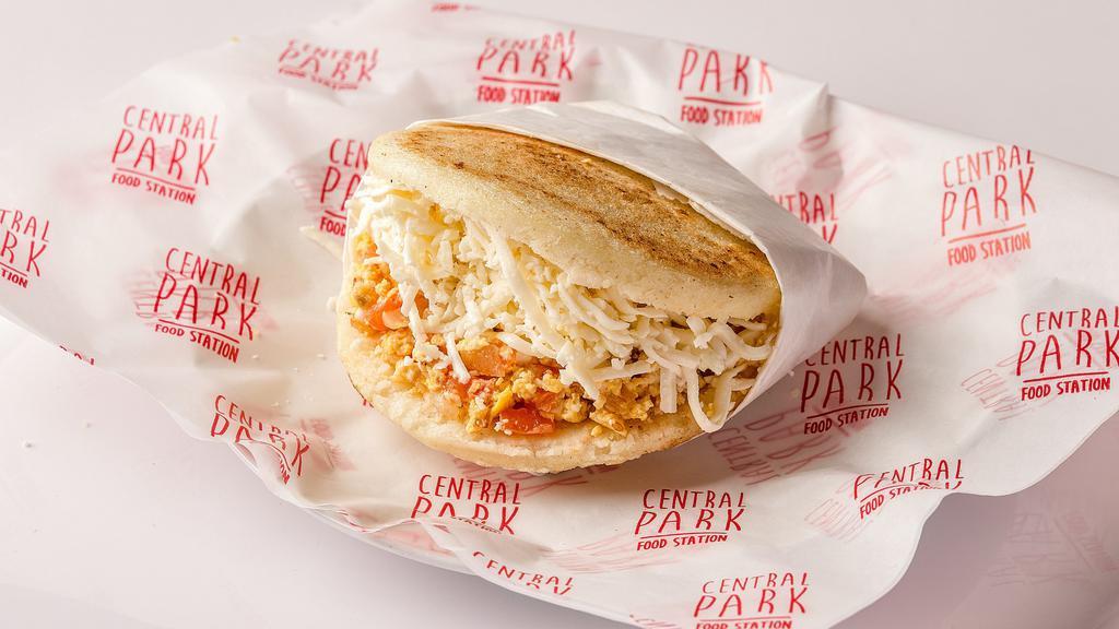 Arepa Perico · Arepa filled with scrambled eggs with onions, tomatoes, and white cheese.