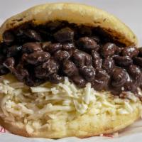 Arepa Domino · Arepa filled with white cheese and black beans.