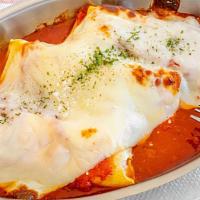 Manicotti · Pasta rolls filled with ricotta and herbs, baked in tomato sauce and mozzarella.