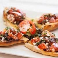 Bruschetta · Sliced bread topped with a traditional blend of fresh feta cheese, fresh tomatoes and balsam...