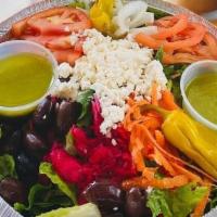 Greek Salad · Lettuce, tomatoes, onions, pepperoncini, kalamata olives, feta cheese and Greek dressing.
