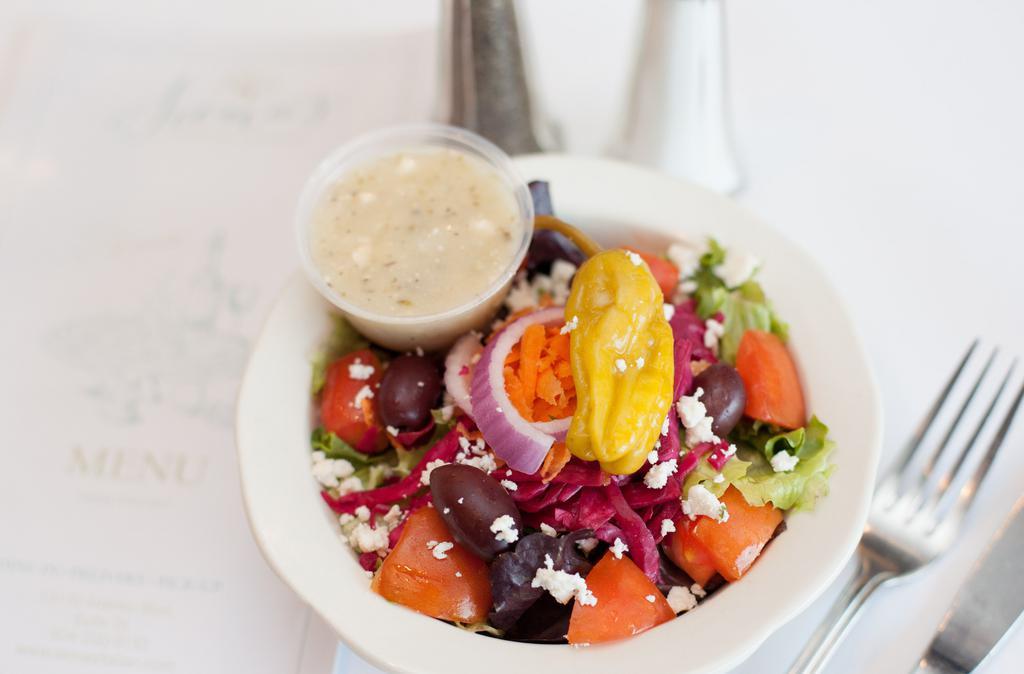 Side Greek Salad · Lettuce, tomatoes, onions, pepperoncini, kalamata olives, feta cheese and Greek dressing.