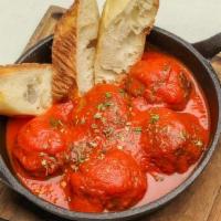 Meatballs · Served with tomato sauce, topped with ricotta cheese and farm style toasted bread.