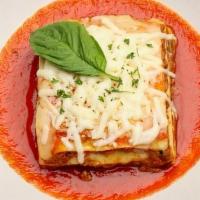 Meat Lasagna · Layers of pasta dough, filled with ragu sauce, ricotta, mozzarella, and parmesan cheese.