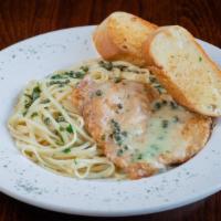 Chicken Piccata Pasta · Pan sautéed chicken cutlet served on a bed of linguine with a lemon butter caper sauce.