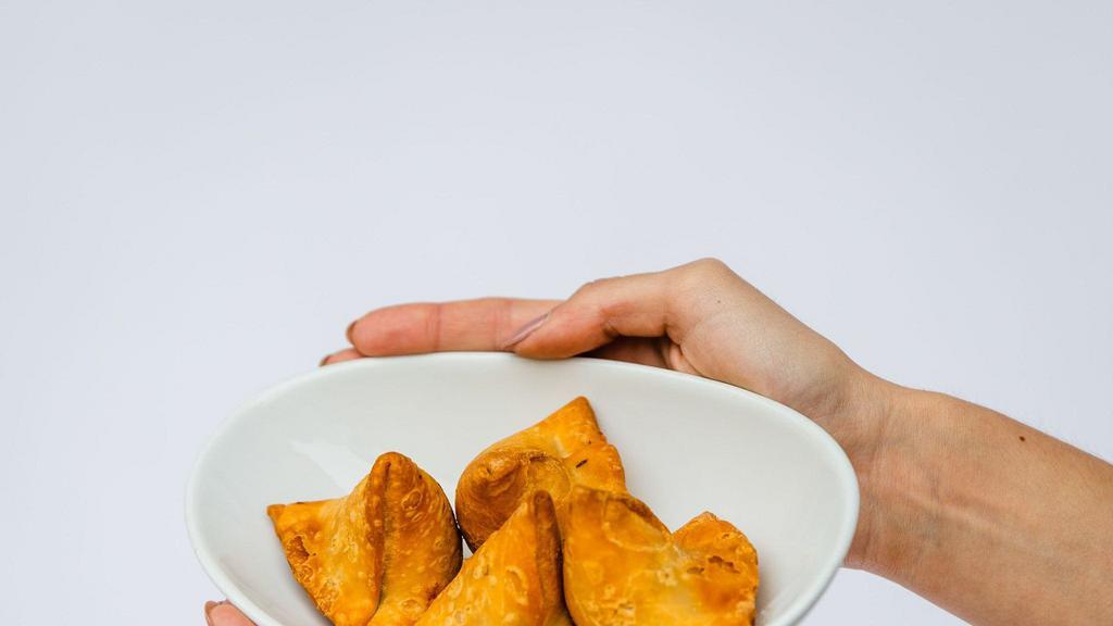 Samosas 4 Pcs · Potato and peas witha an authentic blend of spices stuffed into a triangular pastry served with mint and tamarind chutneys (V)