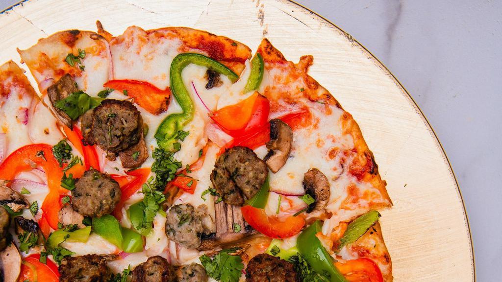 Tandoori Pizza: Seekh Kebab Sausage · Chutney marinara, mozzarella, sliced house made turkey kebab, red onion, mushroom, and bell peppers and cilantro.