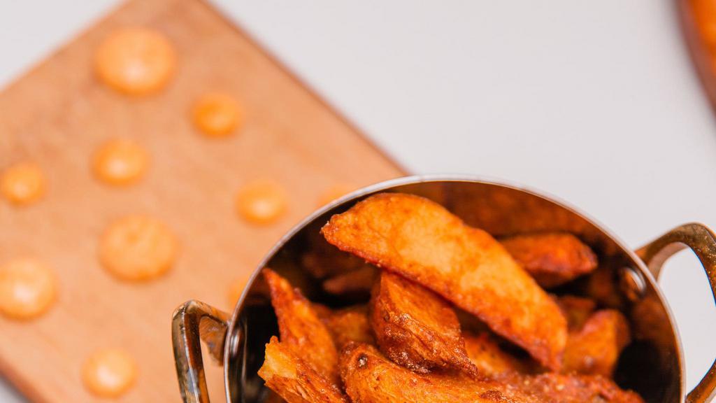 Masala Fries · House made potato wedges with fresh ground spices and herbs. Served with your choice or dipping sauce.