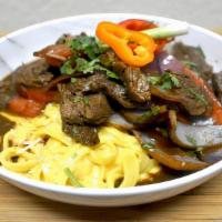Fetuccini A La Huancaina With Lomo Saltado · Fettuccini in yellow pepper Cream with Beef stir-fry, soy sauce