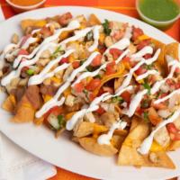 Nachos · Chips with beans, cheese, pico de gallo and sour cream choice of pastor, steak, chicken or s...