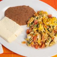 Huevos A La Mexicana · Scrambled eggs with tomatoes, onions and cilantro, side of beans, fresh cheese and corn tort...