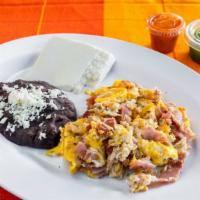 Huevos Revueltos · Scrambled eggs with choice of ham or sausage, side of rice beans, fresh cheese and corn tort...