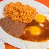Huevos Rancheros · Fried Eggs with red sauce, side of rice, beans and corn tortilla.
Huevos fritos acompanados ...