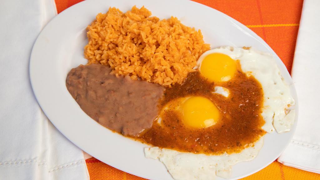 Huevos Rancheros · Fried Eggs with red sauce, side of rice, beans and corn tortilla.
Huevos fritos acompanados con salsa roja, arroz, frijol y tortillas.