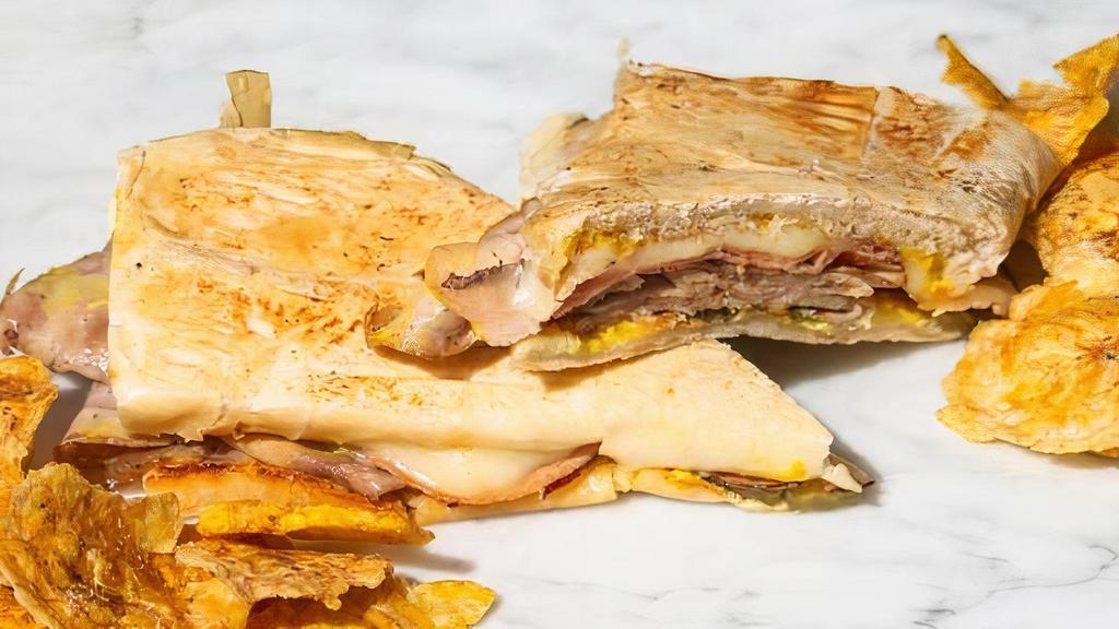 Cuban Sandwich · Braised Pork, Ham, Melted Swiss Cheese, Pickles, and Mustard on a toasted Cuban bread.