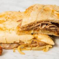 Pan Con Lechón · Braised Pork and Sauteed onions on a toasted Cuban bread.