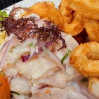 Ceviche Carretillero · Our Clasico fish ceviche topped with fried calamari. Served with sweet potato, corn and canc...