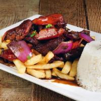 Lomo Saltado · Sautéed beef with onions and tomatoes. Served with white rice and fries.