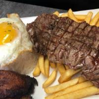 Churrasco Pobre · Grilled steak. Served with rice, fries, plantains, and a fried egg.