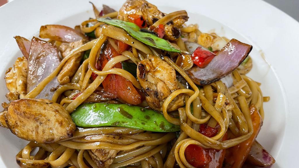 Tallarin Saltado · Peruvian stir fry noodles with chicken, onions, tomatoes, red peppers, green onions, soy sauce, and garlic.
