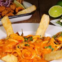 Pescado A Lo Macho · Fish fillet topped with a creamy seafood sauce. Served with white rice and yuca.