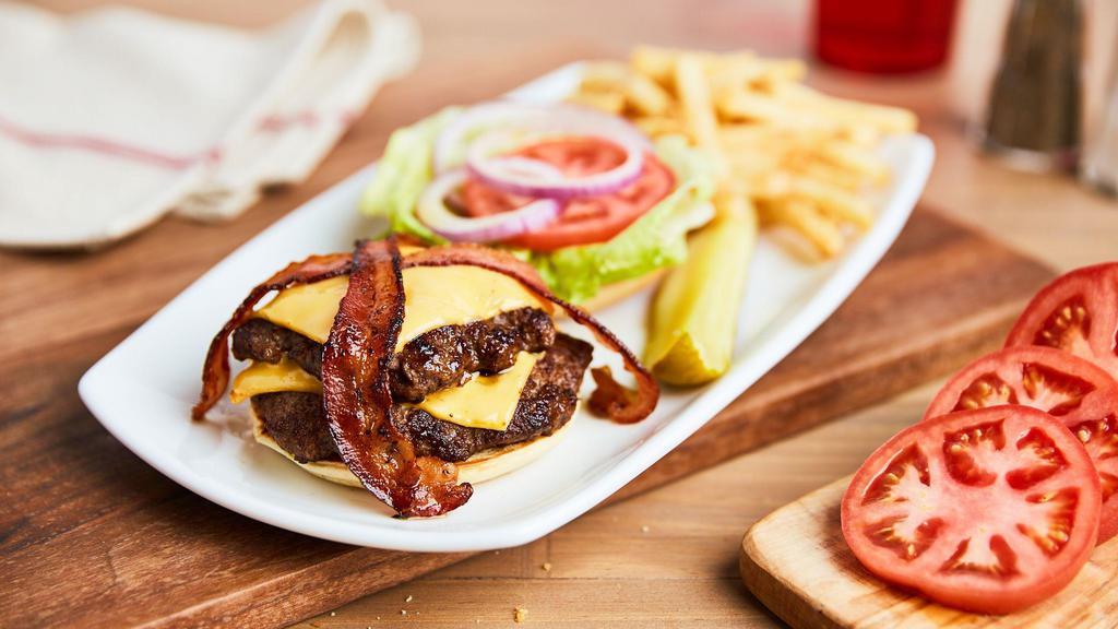 Brusco'S All-American Burger · Two smashball patties, two slices American cheese, topped with lettuce, red onion, pickle chips and tomato.