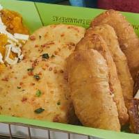 Sample Platter · Fried Arepitas, Cachapa Slices, Tequeños, Tostones. Three of ea. topped with cheese and nata
