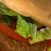 Regular Jack · A regular seasoned jack fruit patty topped with pickles, lettuce, tomato and sauce.