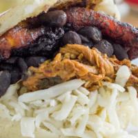 Arepa Pabellon · Shredded meat, black beans, cheese, and plantain.