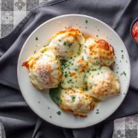 Garlic Knote · Our fresh baked rolls smothered in garlic butter and Parmesan cheese.