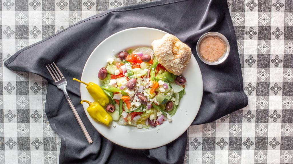 Greek · Tomatoes, kalamata olives, feta cheese, pepperoncinis, red onions, green bell peppers, cucumbers, and our Greek vinaigrette.
