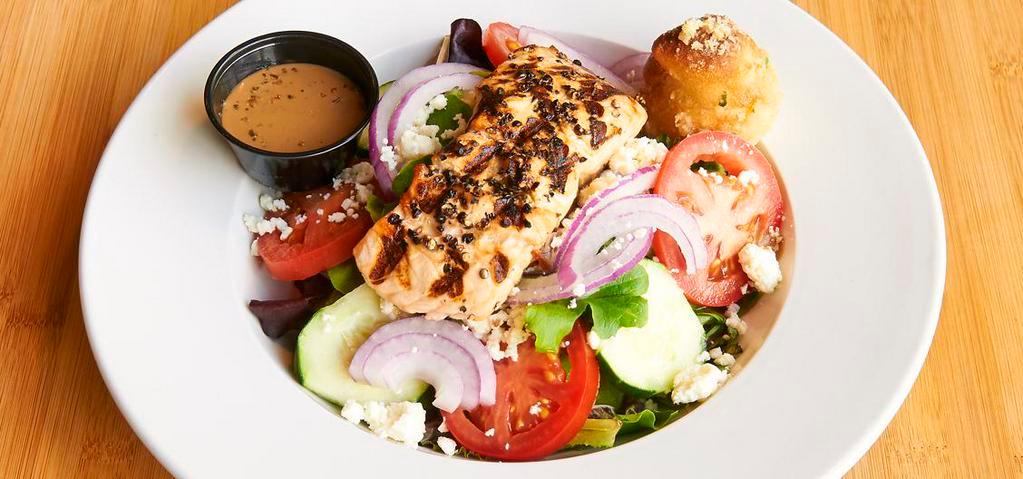 Salmon On The Green · Salmon crusted in peppercorn and seared served on top of mixed greens, fresh tomatoes, cucumbers, red onions, and feta cheese with balsamic vinaigrette.