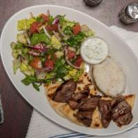 Lamb Shish Kebab · Marinated cubes of baby lamb grilled to delight on skewers. Include side salad, rice, pita b...