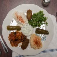 Meze Sampler · Hummus, baba ganush, tabouli, saksuka , stuffed grape leave, and falafel. Served with hot pi...