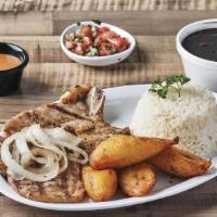 Chuletas De Puerco Asadas · Grilled Pork Chop topped with grilled onions