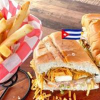 “The Bomb” Chicken Sandwich · Pan Cubano con Bistec de Pollo y Queso Frito servido con Papas Fritas.