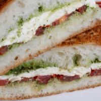 Caprese Sandwich · Vegetarian. Fresh mozzarella, basil, and olive oil puree, and Roma tomatoes on a Parmesan ci...
