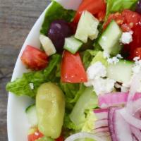 Greek Salad · Crisp romaine lettuce, Roma tomatoes, red onion, cucumbers, Kalamata olives, feta cheese, an...