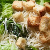Caesar Salad · Crisp romaine lettuce, house croutons, Caesar dressing, and shaved Parmesan cheese.