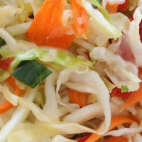 Healthy Slaw · Green cabbage, cucumbers, carrots, red peppers and onions in a sweet vinegar-based dressing.