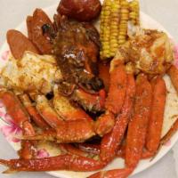 The Crab Box · Dungeness Crab, Soft Shell Crab, Snow Crab Legs with either Sausage Link or Pork.