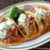 Carnitas Tacos · Braised pork butt, onion, cilantro, avocado salsa, corn tortillas