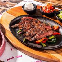 Sizzling Fajitas · All served with sauteed peppers & onions, pico de gallo, chunky guacamole, crema, and queso....