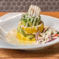 Causa De Camarones · Softly mashed potatoes, lime and yellow pepper combining tasty shrimp with avocado slices.